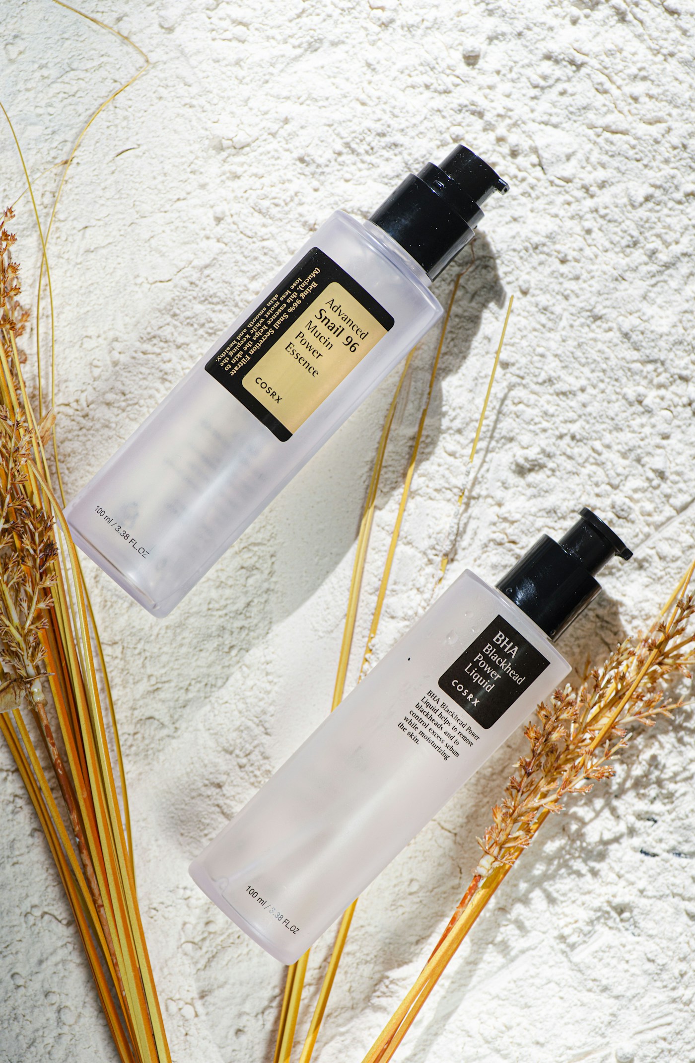 COSRX Snail 96 Essence 100ml with yellow label, beside a separate BHA Blackhead Power Liquid bottle